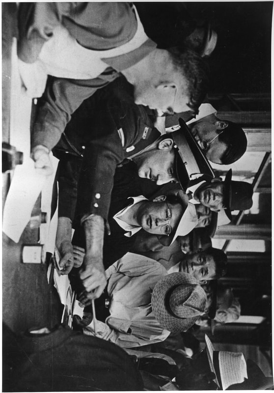 Crowd of Japanese-Canadians around an RCMP officer