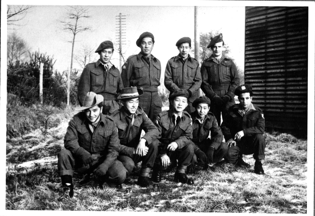 Nine Japanese-Canadian veterans pose for a photo